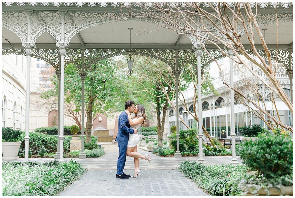 a couple kisses in front of hotel crescent court